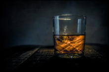 A glass of double oaked bourbon on the rocks.