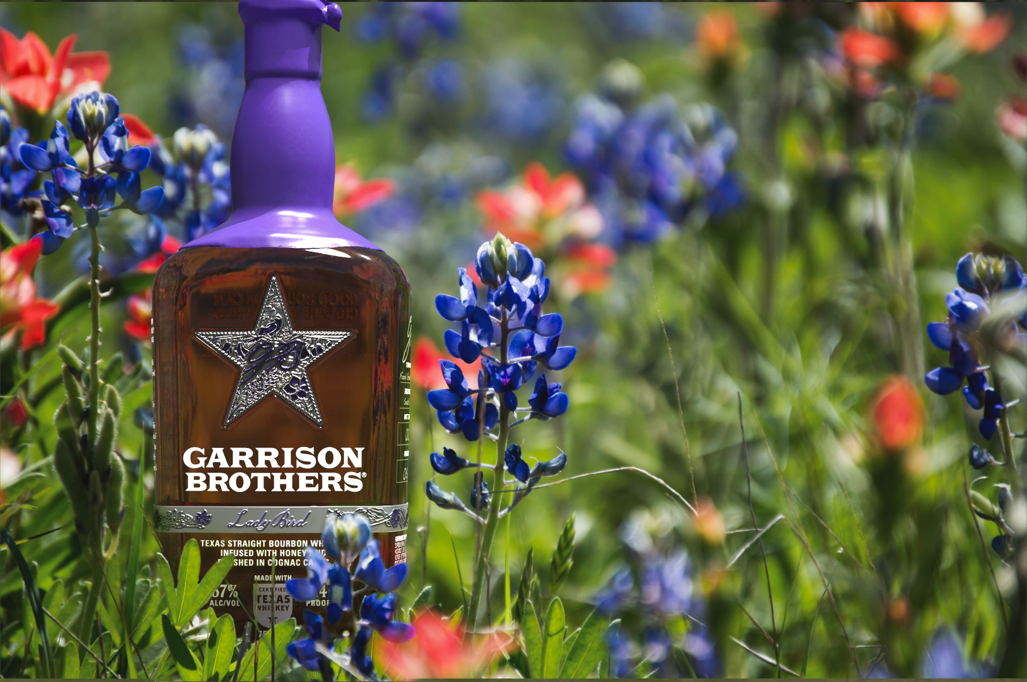 Lady Bird Bourbon from Garrison Brothers in a field of Texas Bluebonnets